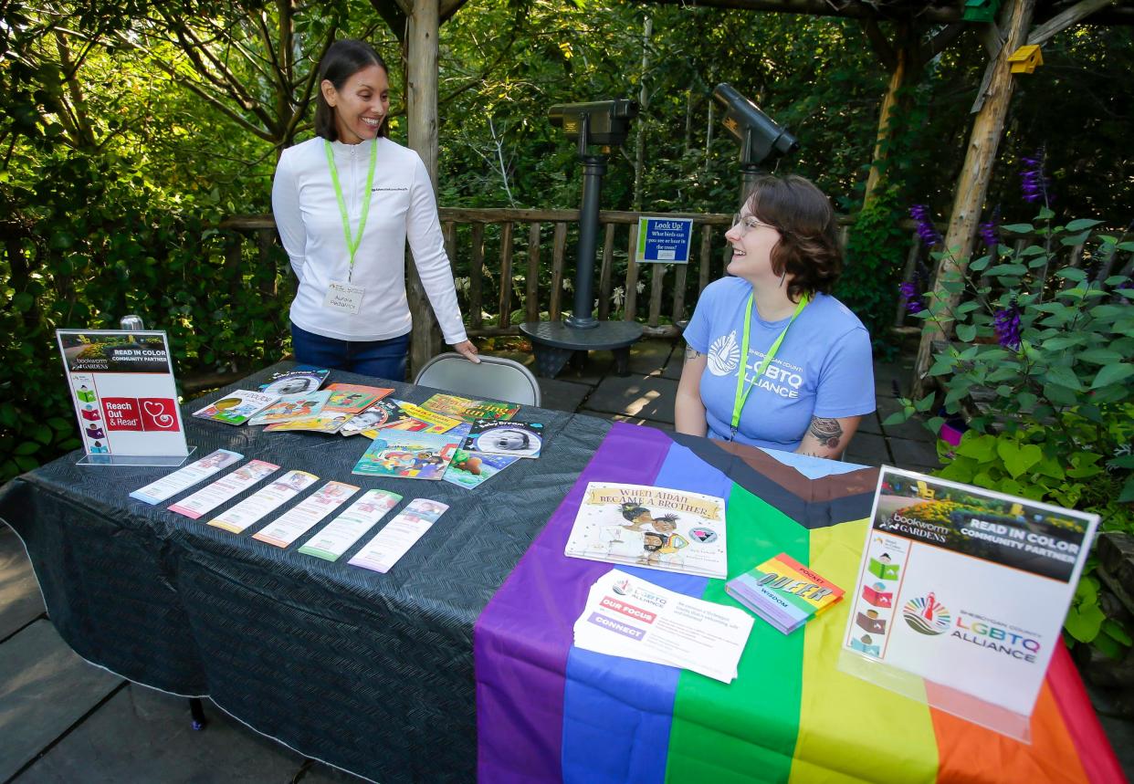 Aurora Pediatrics’ Elise Opel, left, and Sheboygan County LGBTQ Alliance’s Maggie Hernandez talk after setting up their shared table for Read in Color at Bookworm Garden, Saturday, September 9, 2023, in Sheboygan, Wis.