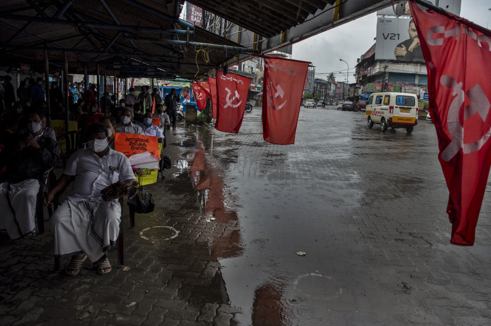 An ambulance rides through a deserted street as left party activists attend a meeting in support of nation-wide shutdown to protest against the contentious farm laws in Kochi, Kerala state, India, Monday, Sept.27, 2021. (AP Photo/R S Iyer)