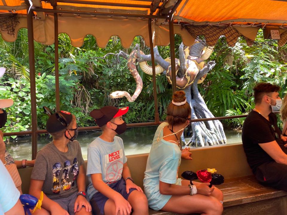 People ride the Jungle Cruise at Disney World in August 2021.