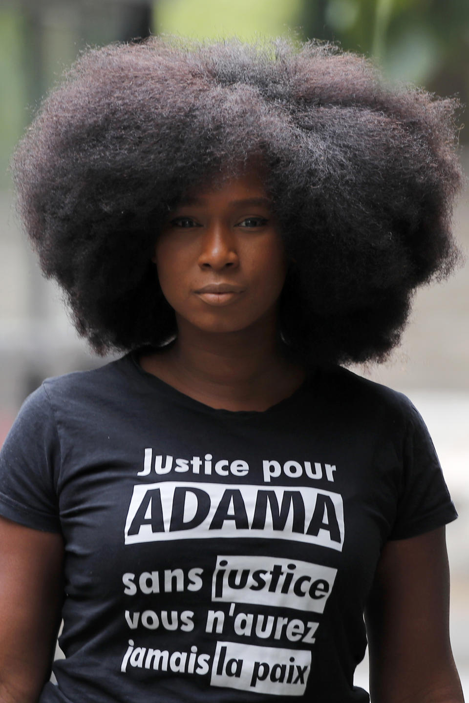 Assa Traore, wearing a shirt that reads: “Justice for Adama, without Justice you will never be in Peace,” attends an interview in Ivry-sur-Seine, on the outskirts of Paris, Wednesday, July 15, 2020. Traore started by fighting for justice for her brother Adama, who died in police custody on his 24th birthday four years ago. She’s now at the forefront of a new movement for Black rights in France that aims to wipe out systemic racism in policing and challenge the country’s official vision of itself as a colorblind society. (AP Photo/Francois Mori)