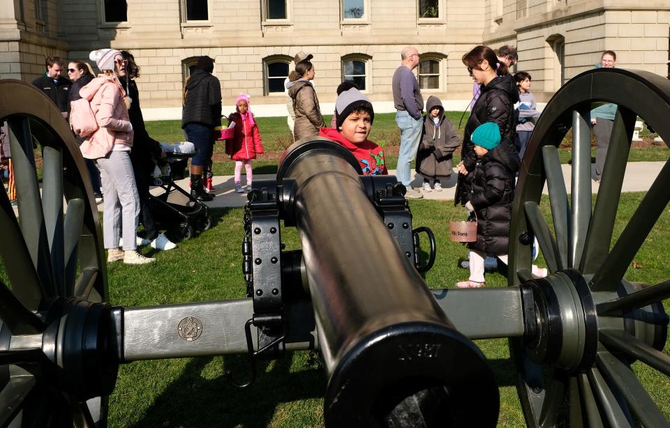 Duncan Greer, 6. from Lansing, checks out the cannon on the Capitol lawn as his mom keeps his place in line to get a balloon from a clown as one of the activities at the annual JCI Easter Egg Hunt on the Capitol Lawn Saturday, April, 8, 2023.