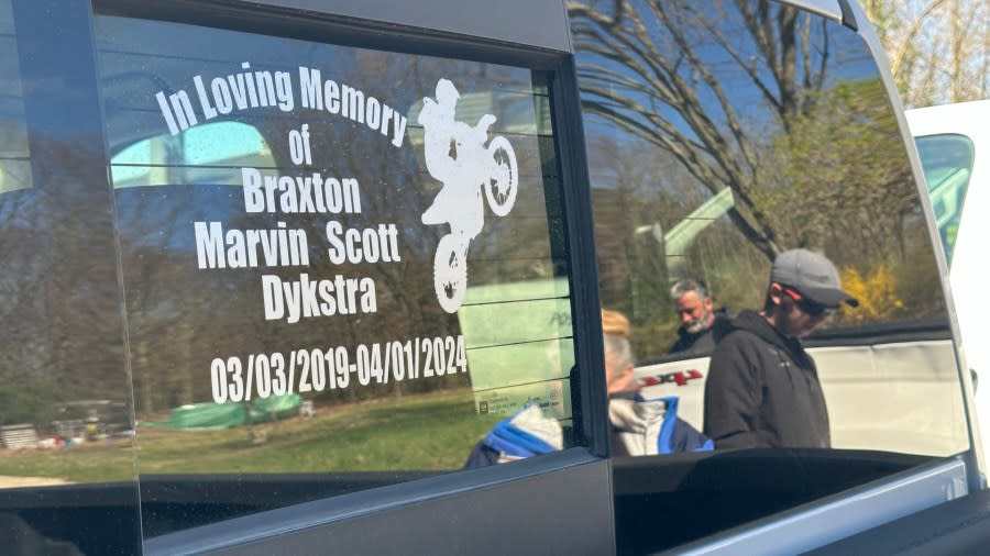 Braxton Dykstra's family can be seen in the reflection of the back window of his truck, where Braxton is memorialized. (April 19, 2024)