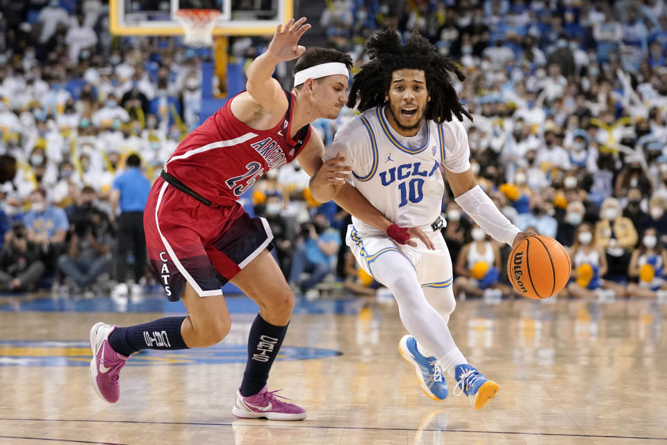 UCLA guard Tyger Campbell, right, drives toward the basket as Arizona guard Kerr Kriisa defends during the second half of an NCAA college basketball game Tuesday, Jan. 25, 2022, in Los Angeles. (AP Photo/Mark J. Terrill)