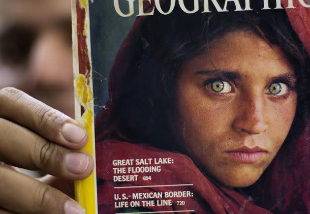 In this file photo from Oct. 26, 2016, Pakistan's Inam Khan shows a copy of a magazine with the photograph of Afghan refugee woman Sharbat Gulla, from his rare collection in Islamabad, Pakistan.  (Photo: AP Photo/B.K. Bangash, File)