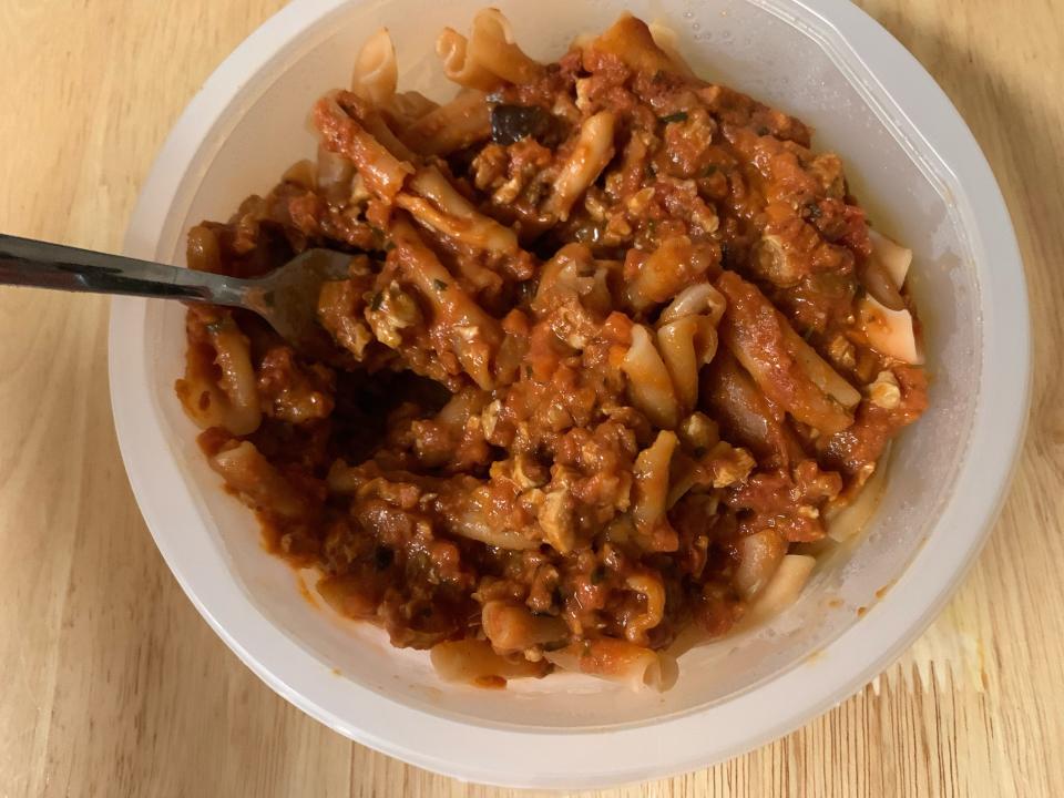 cooked Trader Joe's vegan pasta bolognese in clear microwaveable container