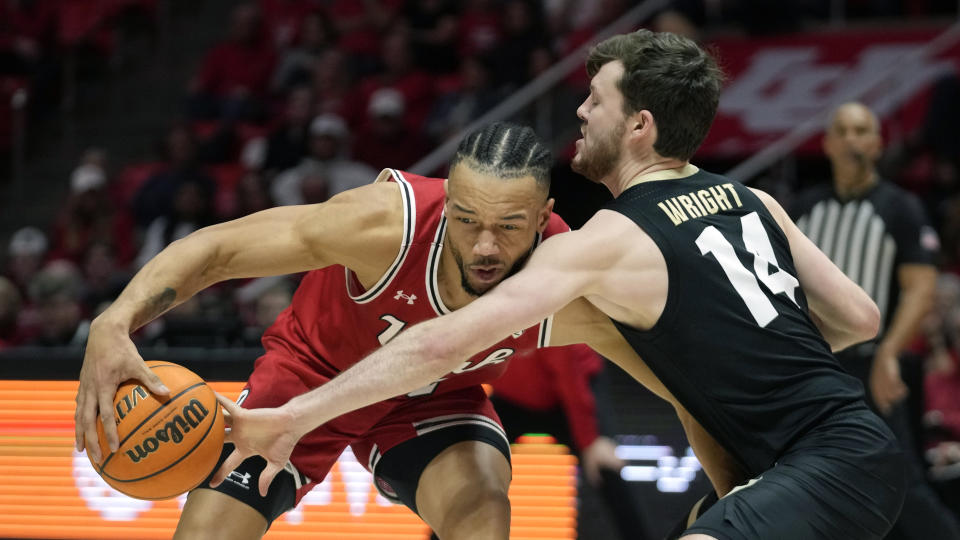 Colorado guard Ethan Wright (14) defends against Utah guard Marco Anthony during the second half of an NCAA college basketball game Saturday, Feb. 11, 2023, in Salt Lake City. (AP Photo/Rick Bowmer)