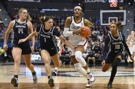 UConn's Aaliyah Edwards, second from right, advances to the basket after stealing the ball while pursued by Georgetown's Kristina Moore (14), Kelsey Ransom (1) and Kennedy Fauntleroy (10) in the second half of an NCAA college basketball game, Sunday, Jan. 15, 2023, in Hartford, Conn. (AP Photo/Jessica Hill)