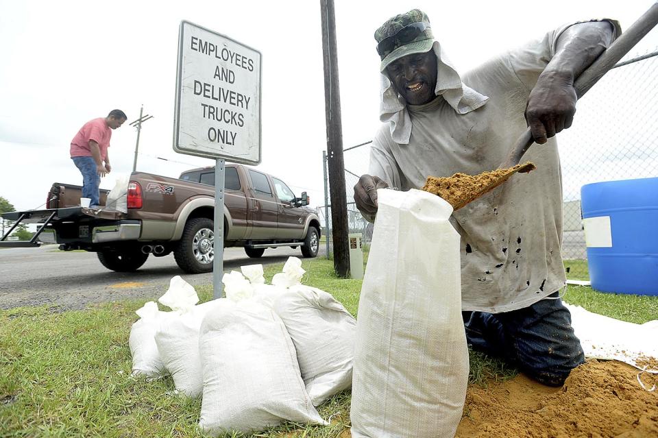 <p>Mike Phillips of Beaumont fills bags with sand at the Jefferson County Precinct 4 Service Center Tuesday, as he and others prepare for potential flooding due to the approaching tropical storm, June 20, 2017. (Photo: Kim Brent/Beaumont Enterprise via AP) </p>