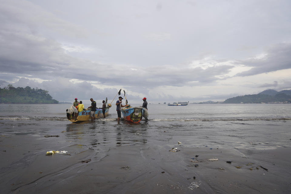 Local Cameroonian fishermen prepare fishing nets on their boats along the shores of Limbe beach, Cameroon, on April 12, 2022. In recent years, Cameroon has emerged as one of several go-to countries for the widely criticized “flags of convenience” system, under which foreign companies can register their ships even though there is no link between the vessel and the nation whose flag it flies. But experts say weak oversight and enforcement of fishing fleets undermines global attempts to sustainably manage fisheries and threatens the livelihoods of millions of people in regions like West Africa. (AP Photo/Grace Ekpu)