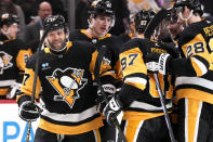 Pittsburgh Penguins' Bryan Rust, left, celebrates his goal against the Carolina Hurricanes during the second period of an NHL hockey game in Pittsburgh, Tuesday, March 26, 2024. (AP Photo/Gene J. Puskar)