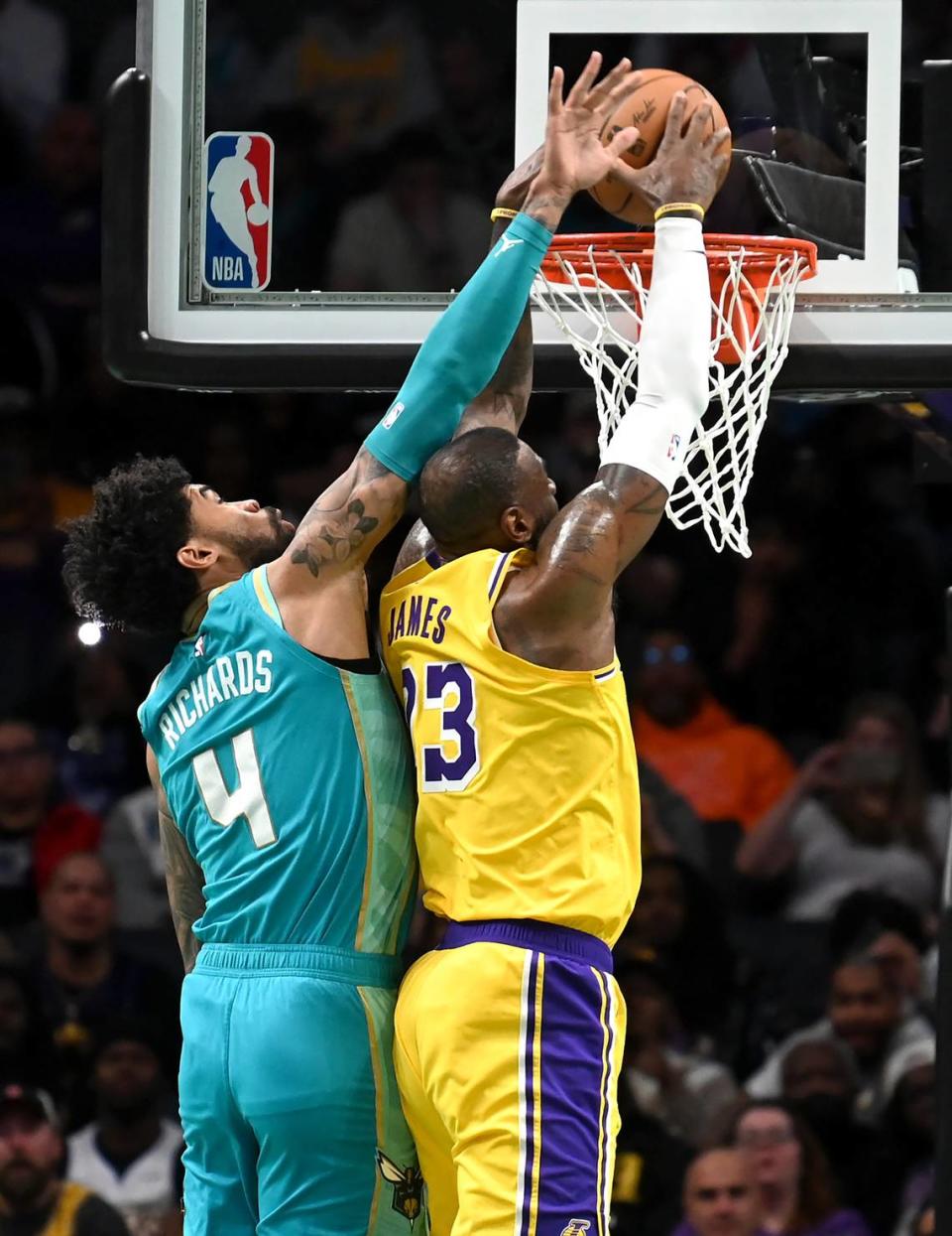 Charlotte Hornets center Nick Richards, left, is unable to stop Los Angeles Lakers forward LeBron James, right, from throwing down a two-handed dunk during first half action on Monday, February 5, 2024 at Spectrum Center in Charlotte, NC.
