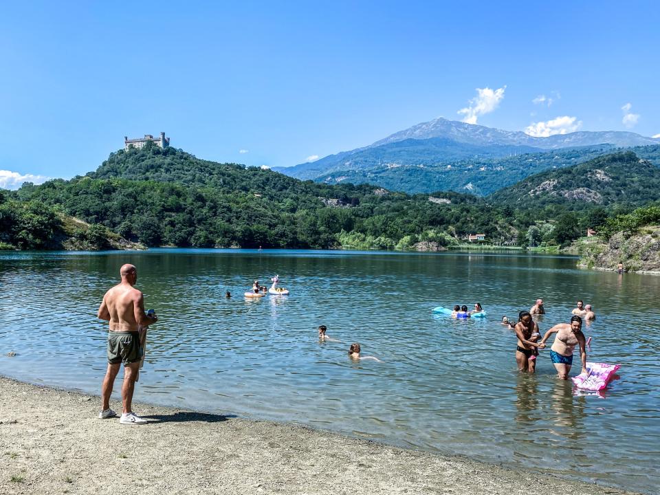 People bathe in the area of Lake Sirio to cool off, in the province of Turin, Italy (EPA)