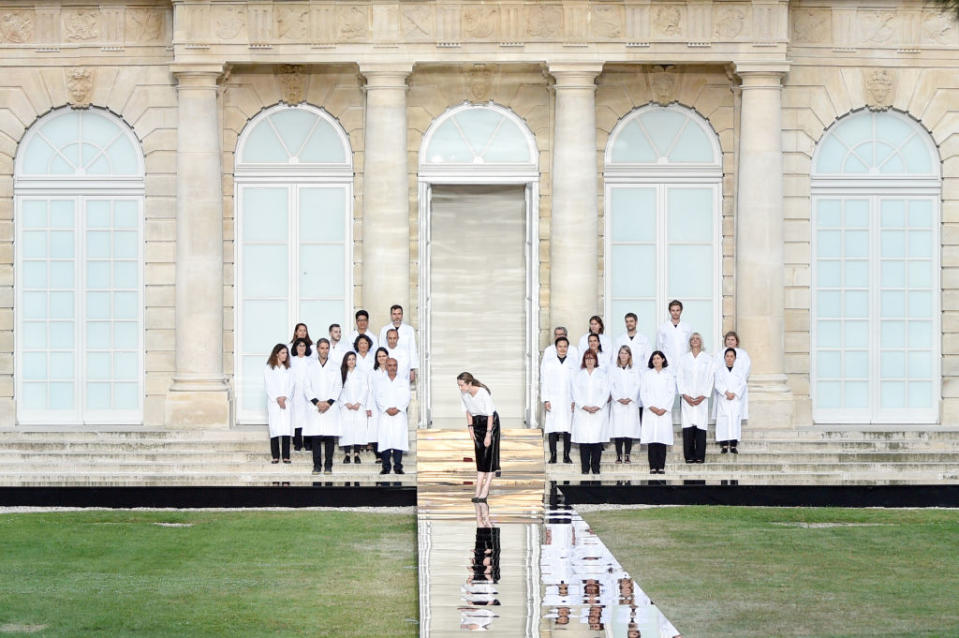 <p>Clare Waight Keller bows at the end of her Givenchy fall 2018 couture show with her atelier team. (Photo: Getty Images) </p>