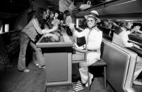 <p>Elton John travels on his 1974 U.S. tour on a private jet complete with a piano bar. </p>