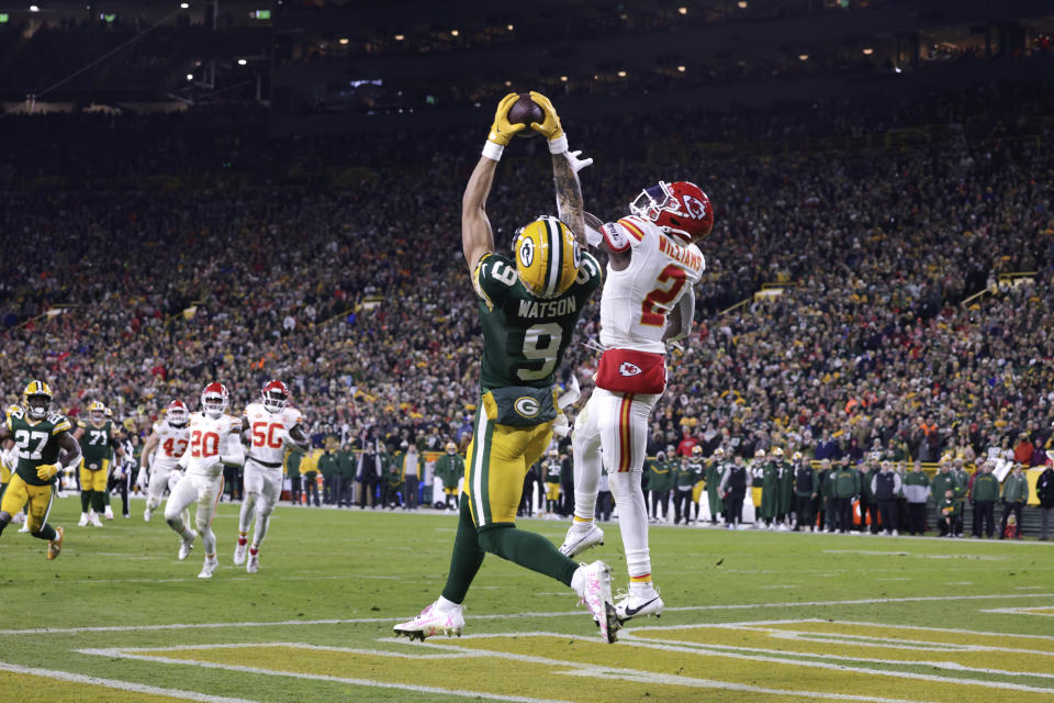 Green Bay Packers wide receiver Christian Watson (9) catches a 12-yard touchdown pass as Kansas City Chiefs cornerback Joshua Williams (2) defends during the second half of an NFL football game Sunday, Dec. 3, 2023 in Green Bay, Wis. (AP Photo/Matt Ludtke)