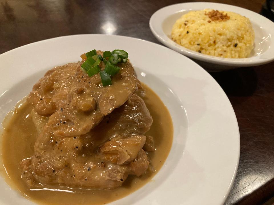 Adobo sa gata — Filipino chicken stew in coconut milk, soy sauce, vinegar and spices — with a side dish of garlic rice Jan. 11, 2023 at Nagueños Filipino-American Diner in Essex Junction.