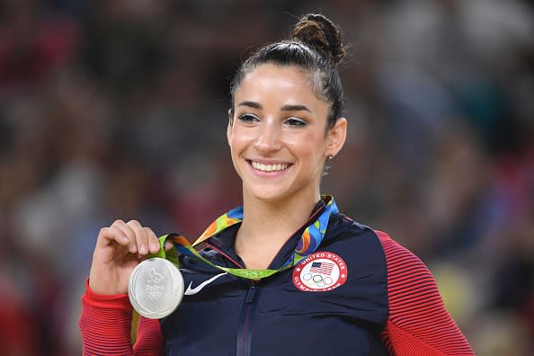 U.S. gymnast Alexandra Raisman celebrates on the podium of the women's floor event final of the Artistic Gymnastics at the Olympic Arena during the Rio 2016 Olympic Games in Rio de Janeiro on August 16, 2016. | AFP—Getty Images