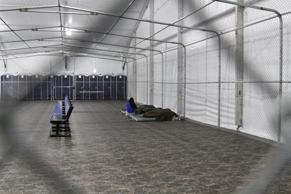 FILE - in this Aug. 15, 2019, file photo, migrants are detained in a tented, air-conditioned cage at a Border Patrol detention facility in Tornillo, Texas. A Border Patrol detention facility in West Texas could be a case study in wasting congressional funds money according to a report released this week by a congressional watchdog. In a period of five months, Customs and Border Protection paid around $5 million for food that was never ordered, about 650,000 unneeded meals, according to the Government Accountability Office report released Thursday, April 9, 2020. (AP Photo/Cedar Attanasio File)