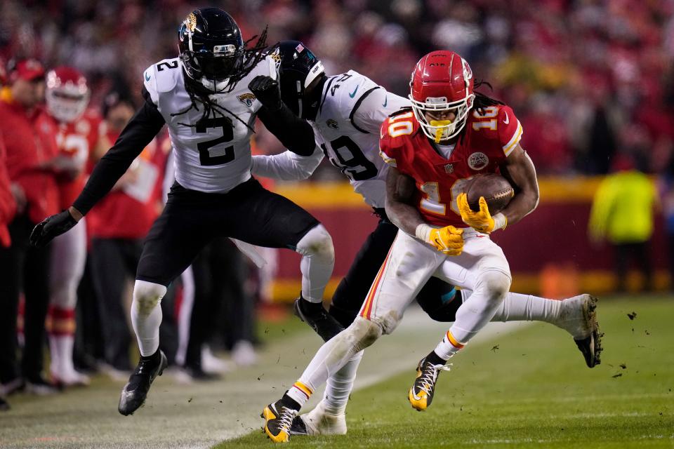 Kansas City Chiefs running back Isiah Pacheco (10) runs against Jacksonville Jaguars safety Rayshawn Jenkins (2) and defensive end Arden Key (49) during the second half of an NFL divisional round playoff football game, Saturday, Jan. 21, 2023, in Kansas City, Mo. (AP Photo/Jeff Roberson)