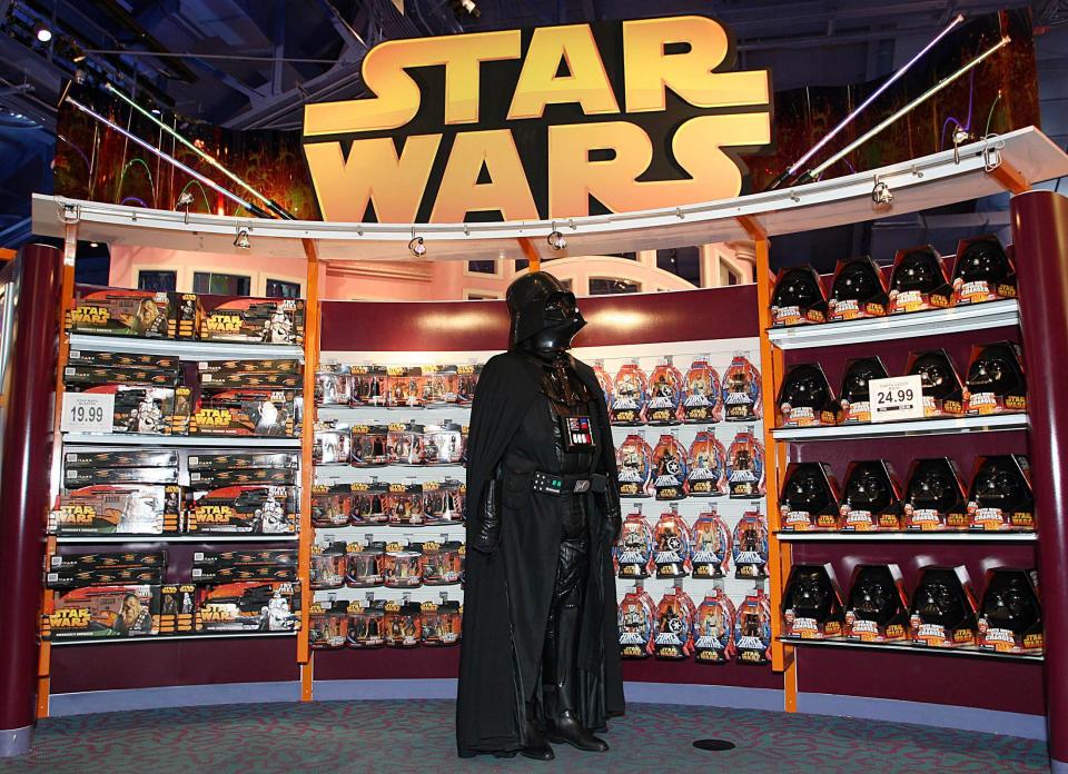 A Star Wars fan dressed as Darth Vader waits for a midnight sale of toys from the new Star Wars movie at Toys 'R' Us in Manhattan, New York on April 1, 2005.