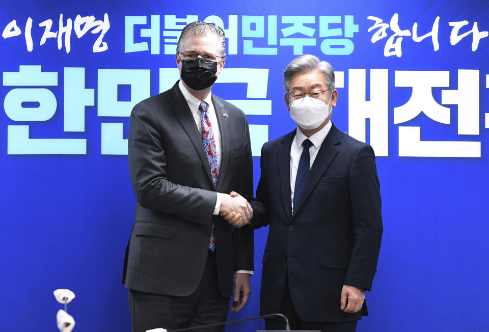 U.S. Assistant Secretary of State for East Asian and Pacific Affairs Daniel J. Kritenbrink, left, shakes hands with South Korean Presidential candidate Lee Jae-myung at the ruling Democratic Party headquarters in Seoul, South Korea, Thursday, Nov. 11, 2021. Kritenbrink arrived in South Korea on Wednesday on the second leg of his two-stop Asia trip and will meet with senior government officials. (Kim Min-hee/Pool Photo via AP)