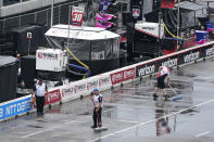Crew members wait out a weather delay before the start of the Music City Grand Prix auto race Sunday, Aug. 7, 2022, in Nashville, Tenn. (AP Photo/Mark Humphrey)