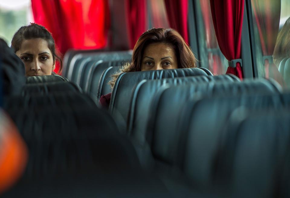 Kurdish Iraqi women leave aboard a bus the 'Jungle' migrant camp in Calais, northern France, on October 12, 2016, for a reception and guidance centre (CAO - Centre d'accueil et d'orientation).&nbsp;