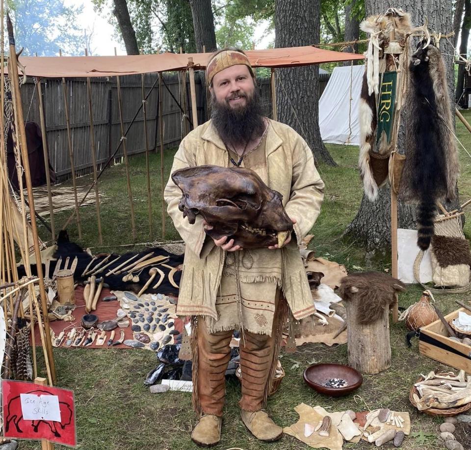 Sean Sullivan holds a molded skull of an extinct species of bear while at one of his presentations. The skull was made for demonstration purposed, but Sullivan made most of the tools, weapons and clothing items himself.