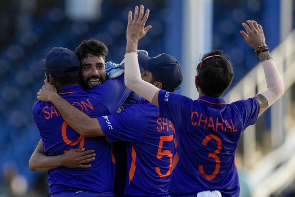 Teammates embrace India's bowler Mohammed Siraj after defeating West Indies for 3 runs in their first ODI cricket match at Queen's Park Oval in Port of Spain, Trinidad and Tobago, Friday, July 22, 2022. (AP Photo/Ricardo Mazalan)