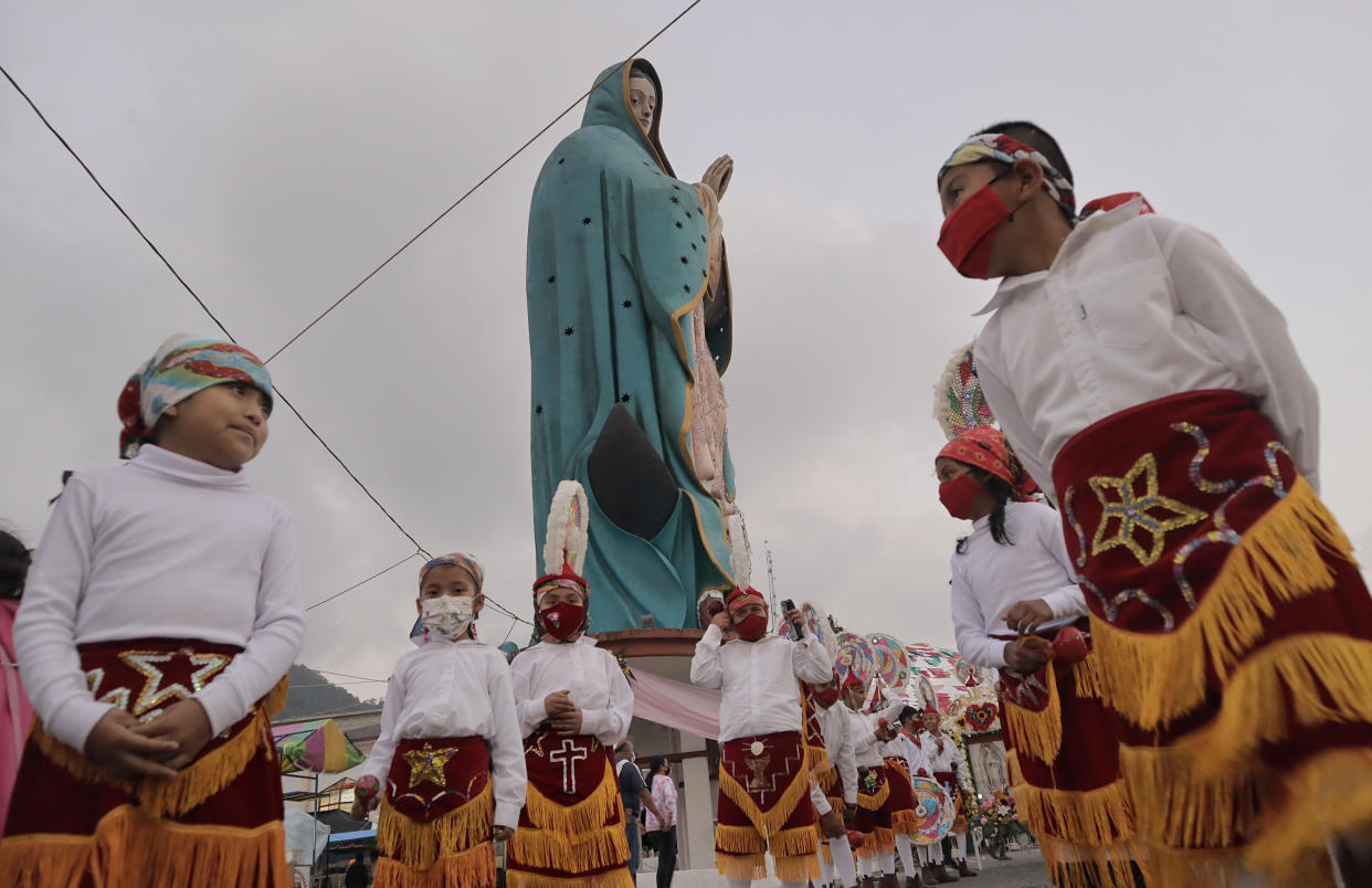 Dancers and pilgrims in the square of the Monumental Virgen de Guadalupe in the Sierra Norte de Xicotepec de Juárez Puebla, Mexico, before performing the Danza de los Quetzales on the occasion of the celebration of the Day of the Virgin of Guadalupe in the country.
 (Photo by Gerardo Vieyra/NurPhoto via Getty Images)