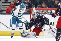 San Jose Sharks forward Fabian Zetterlund (20) scores past Columbus Blue Jackets goalie Daniil Tarasov (40) during the second period of an NHL hockey game in Columbus, Ohio, Saturday, March 16, 2024. (AP Photo/Paul Vernon)