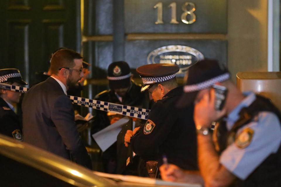 NSW Police are seen outside of an apartment building on Clarence Street after a woman's body was found.