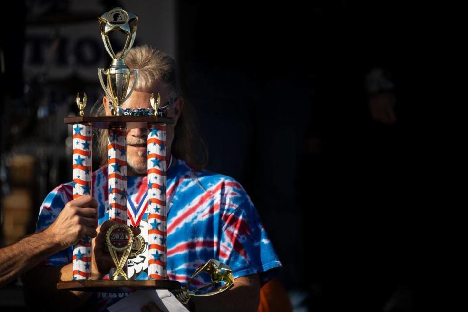 Scott Collard, of Beaver Dam, is awarded the overall winner trophy after competing in the mullet competition during the 2021 Mt. Sterling Court Day Festival on Saturday.