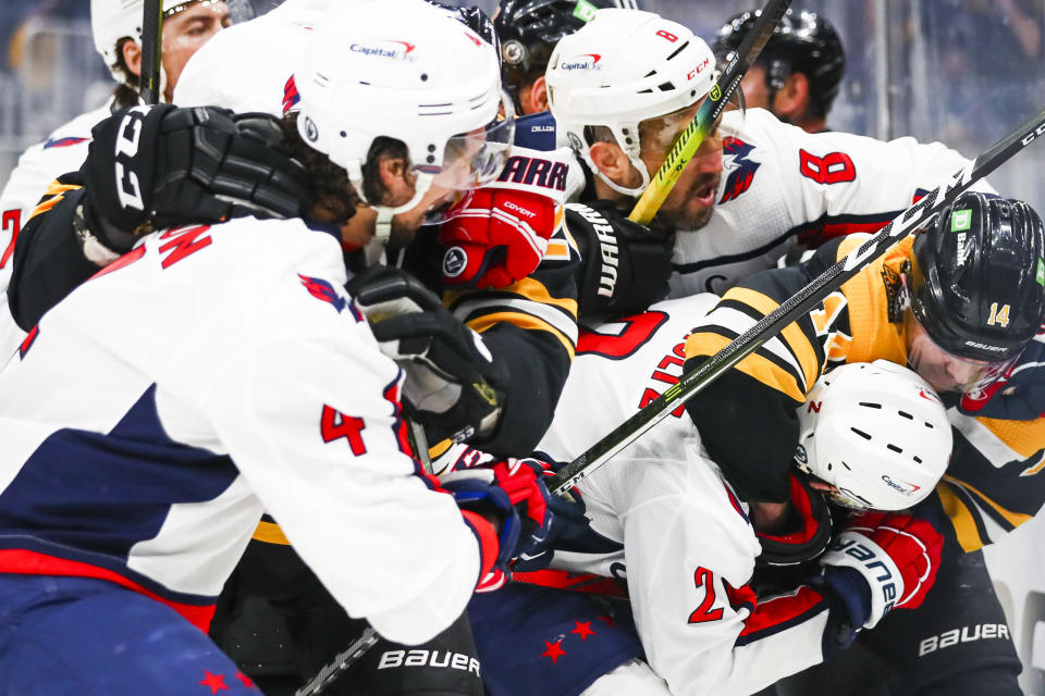 BOSTON, MA - MAY 19: Chris Wagner #14 of the Boston Bruins and Justin Schultz #2 of the Washington Capitals fight for the puck in Game Three of the First Round of the 2021 Stanley Cup Playoffs at TD Garden on May 19, 2021 in Boston, Massachusetts. (Photo by Adam Glanzman/Getty Images)