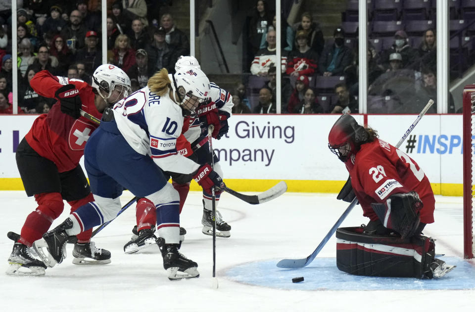 Switzerland goaltender Saskia Maurer (29) makes a save against United States forward Rebecca Gilmore (10) during the first period of a match at the Women's World Hockey Championships in Brampton, Ontario, Friday, April 7, 2023. (Nathan Denette/The Canadian Press via AP)