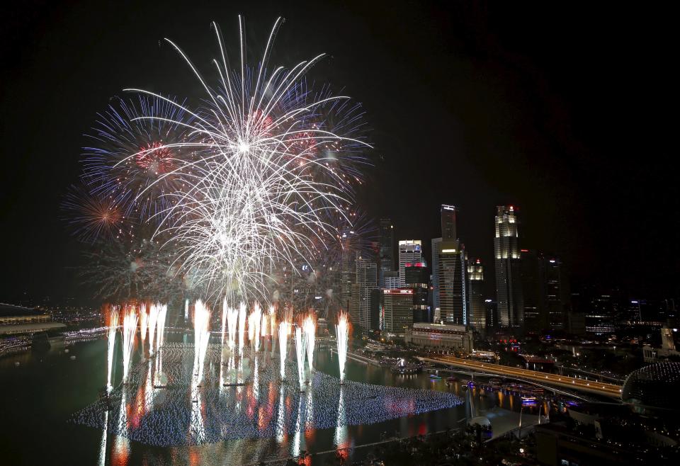 Fireworks explode in Marina Bay against the skyline of Singapore during New Year's Day celebrations