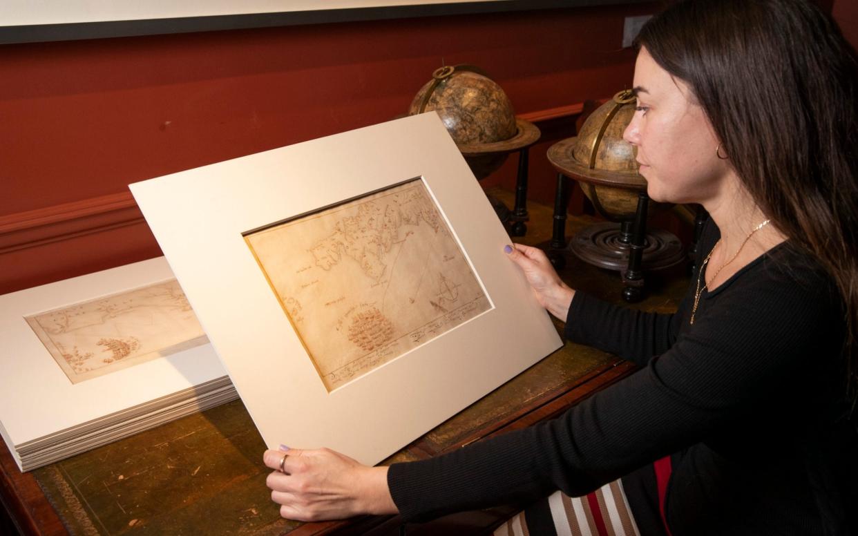 Elena Napoleone, gallery manager at Daniel Crouch Rare Books, looks through the rare drawings - Heathcliff O'Malley/The Telegraph