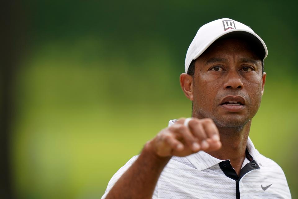 Tiger Woods catches a ball on the range before a practice round for the PGA Championship golf tournament Tuesday in Tulsa, Okla.