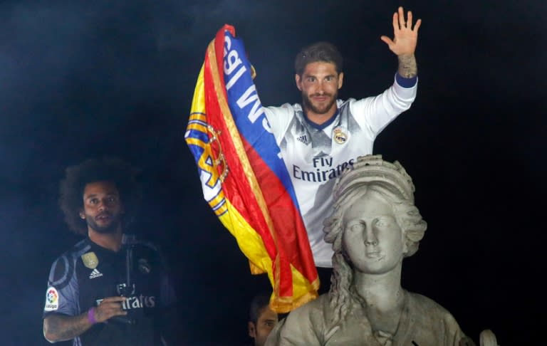 Real Madrid's captain Sergio Ramos (R) and defender Marcelo celebrate the team's La Liga title, at the Plaza de Cibeles in Madrid, on May 21, 2017