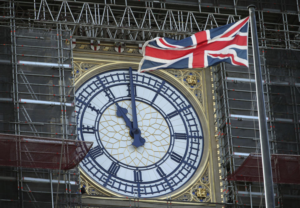 Big Ben's clock face marks eleven o'clock, starting a two minute silence to honour Armistice Day, at the Palace of Westminster in London, Monday Nov. 11, 2019.  Locations across the country are marking guns falling silent to end hostilities and end World War One, on the eleventh hour of the eleventh day of the eleventh month of 1918. (Yui Mok/PA via AP)