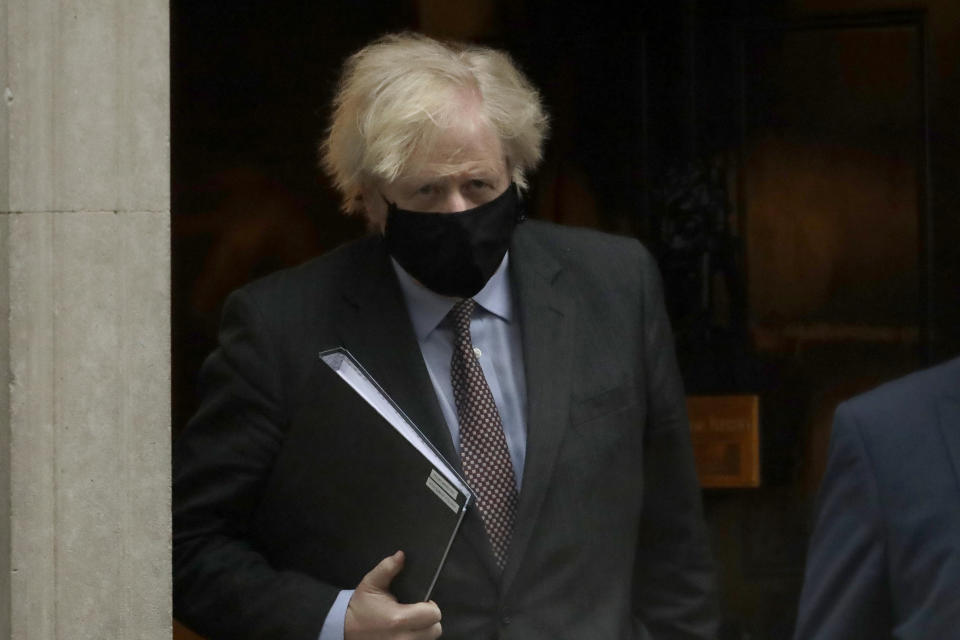 British Prime Minister Boris Johnson leaves 10 Downing Street to go to the Houses of Parliament, in London, Monday, Feb. 22, 2021. Johnson on Monday is expected to announce a plan to ease coronavirus restrictions in increments, starting by reopening schools in England on March 8. (AP Photo/Matt Dunham)