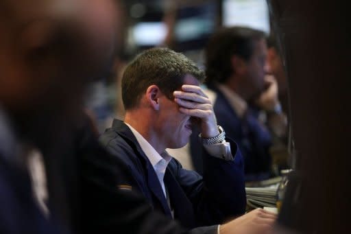 Traders work on the floor of the New York Stock Exchange. The plodding US economy, meager job growth and market tensions over Europe's debt crisis will hang over Federal Reserve policymakers when they meet next week