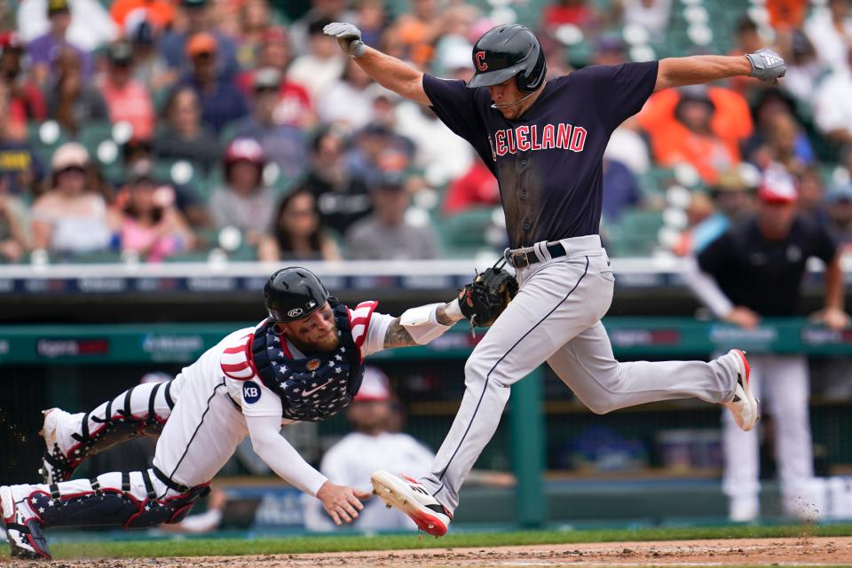 Detroit Tigers catcher Tucker Barnhart tags Guardians outfielder Myles Straw out at home plate in the third inning of  Monday's game in Detroit. The Tigers won the first game of a day-night doubleheader 4-1. [Paul Sancya/Associated Press]