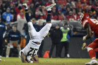 Los Angeles Chargers running back Justin Jackson (32) is upended after a tackle by Kansas City Chiefs cornerback Kendall Fuller, unseen, during the second half of an NFL football game in Kansas City, Mo., Thursday, Dec. 13, 2018. (AP Photo/Ed Zurga)