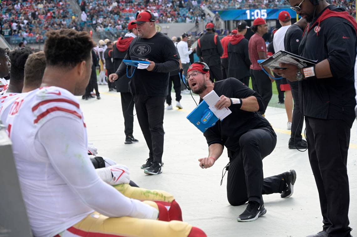 San Francisco 49ers defensive line coach Kris Kocurek, center, talks to players on the sideline during the first half of an NFL football game against the Jacksonville Jaguars, Sunday, Nov. 21, 2021, in Jacksonville, Fla. (AP Photo/Phelan M. Ebenhack)