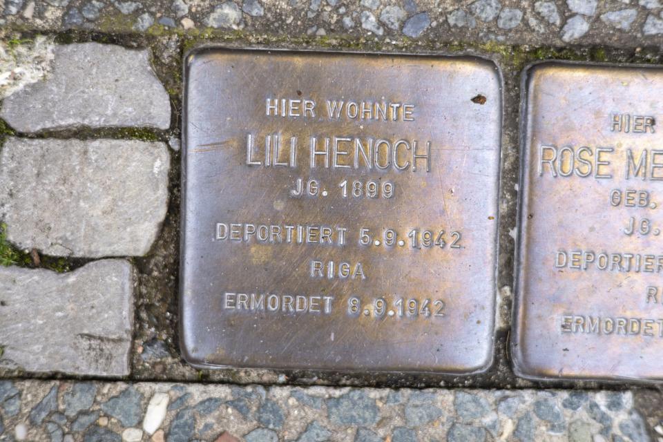 A Stolperstein ("stumbling stone") to commemorate former German athlete Lilli Henoch outside her former home in Berlin, Wednesday, Aug. 2, 2023. Henoch coached athletes at the Bar Kochba Berlin, a club founded in 1898 to promote Jewish participation in sports. When the Nazis came to power, they forced Jewish athletes to take part in separate competitions and then banned Jewish organizations outright in 1938. Its successor, Makkabi Berlin, will be the first Jewish team to play in the German Cup when it hosts Wolfsburg on Aug. 13. (AP Photo/Ciaran Fahey)