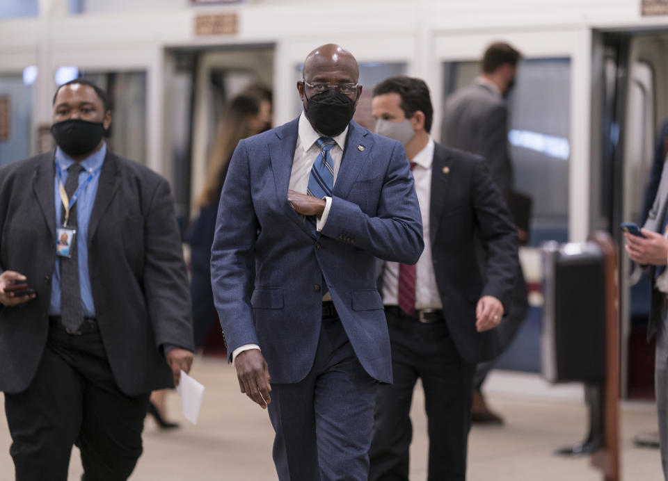 Sen. Raphael Warnock, D-Ga., arrives as the Senate holds votes on nominees for the Biden administration, at the Capitol in Washington, Tuesday, March 16, 2021. (AP Photo/J. Scott Applewhite)