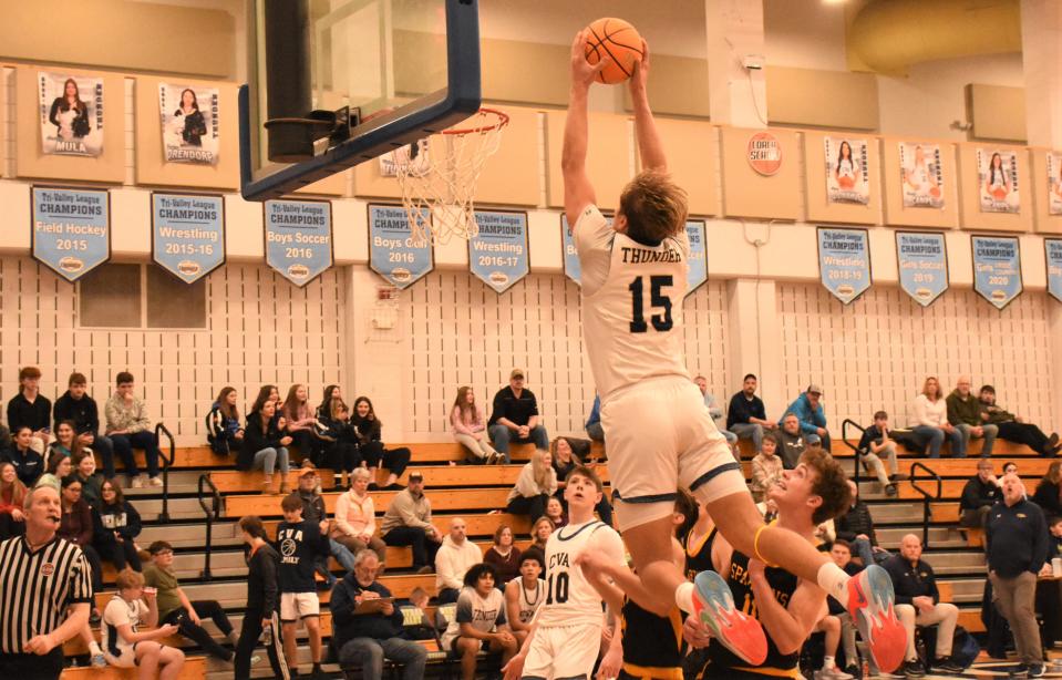 Central Valley Academy senior Deacon Judd (15) soars toward the rim with an alley-oop dunk during the second half Saturday against South Jefferson.