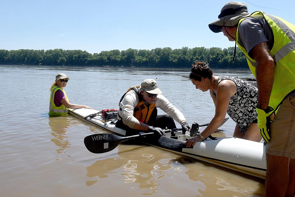 Missouri American Water MR340 volunteers Martha Daniels, left, of Hartsburg, and Scott Snyder, right, of St. Louis, steady the kayak of Kevin Arpier while Arpier’s wife, Laurie, helps him out of the kayak on Wednesday at Cooper's Landing Campgrounds & Marina. Arpier is from Traverse City, Michigan, and is competing in his seventh MR340 race. The MR340 is an endurance race that begins in Kansas City and ends in St. Charles.