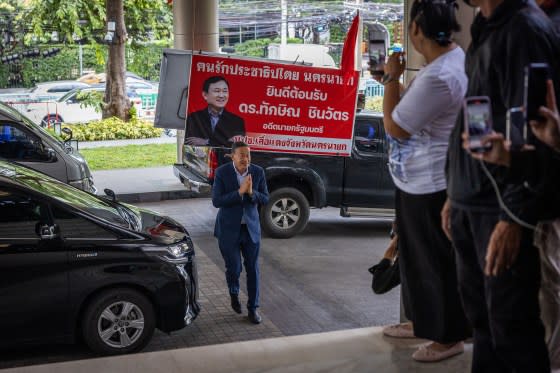 Srettha Thavisin greets supporters, in front of an image of former Thai Prime Minister Thaksin Shinawatra, as he arrives at Pheu Thai Party's headquarters on Aug. 22 in Bangkok. <span class="copyright">Lauren DeCicca—Getty Images</span>